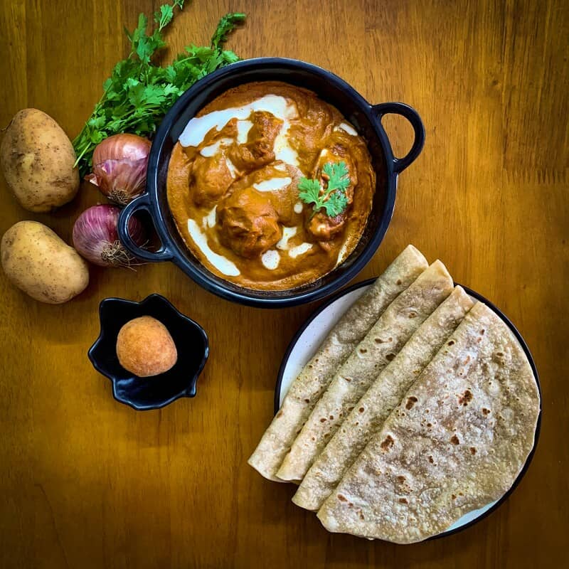 Plates of chapati and meatballs with cream sauce